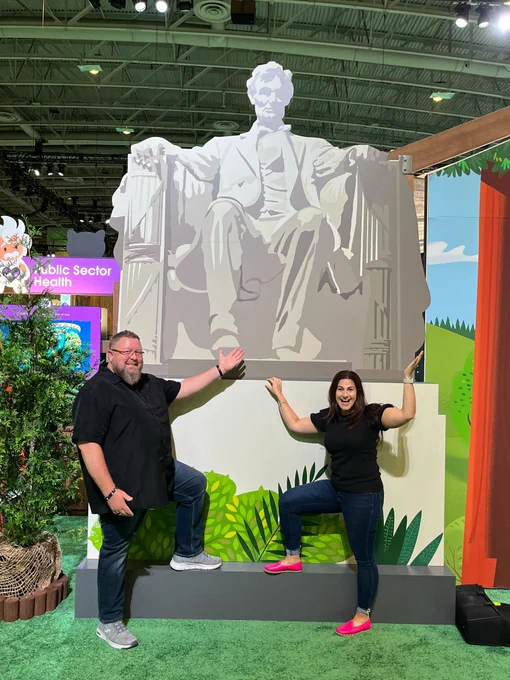 Mike Gerholdt and Lisa Dick posing in front of a cut out of the Lincoln Memorial at Salesforce World Tour Washington D.C. 