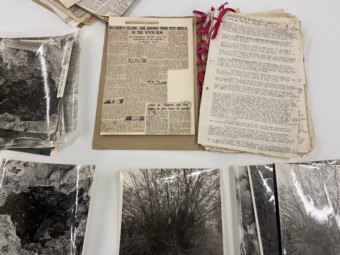 old documents and old photos laid out on a white table