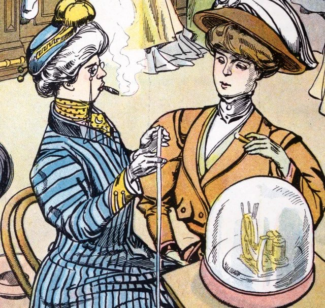 Two women converse as they smoke.