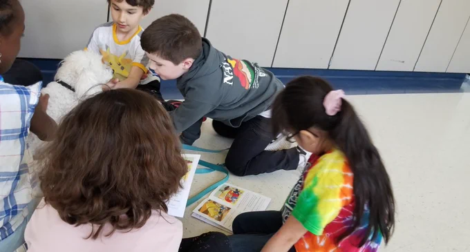 Students reading to dog