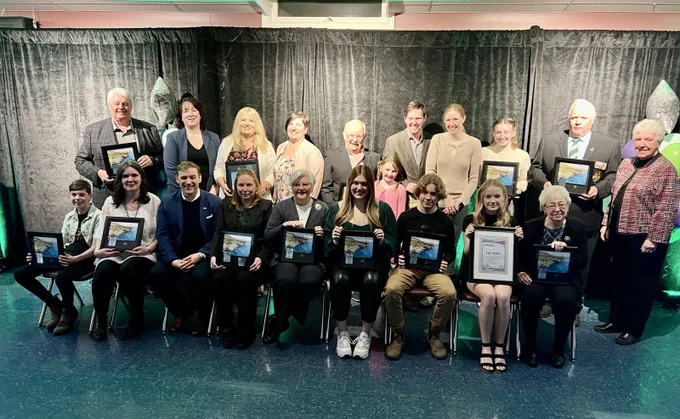 Premier Furey and the winners fill the photo, with the winners holding their awards. 
