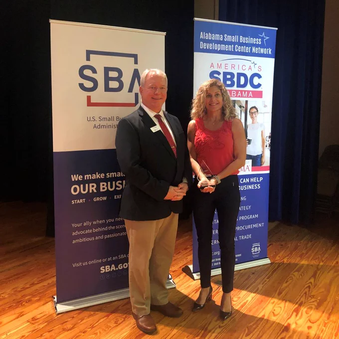 Deputy District Director, L.D. Ralph on left stands next to Sydney Cody, owner of Vanguard Pacific LLC and winner of Veteran- Owned Small Business of the Year.