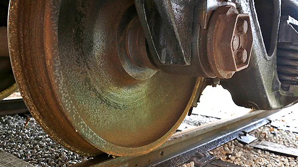 A close-up photo of train wheels on tracks