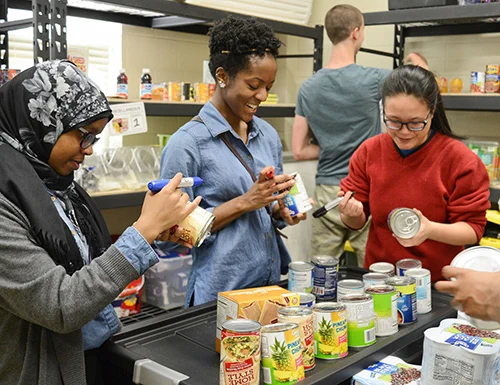 Photo: Students at Durham Tech sort food at the Campus Harvest Food Pantry. 