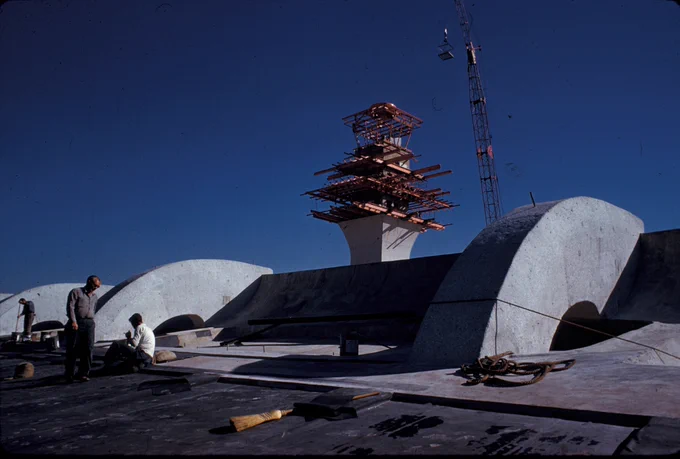Color photo from the top of Washington Dulles International Main Terminal while it's under construction in the 1960s. The frame of the Historic Terminal can be seen in the background. 