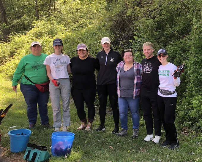 A group of 7 volunteers stand together for a picture. 