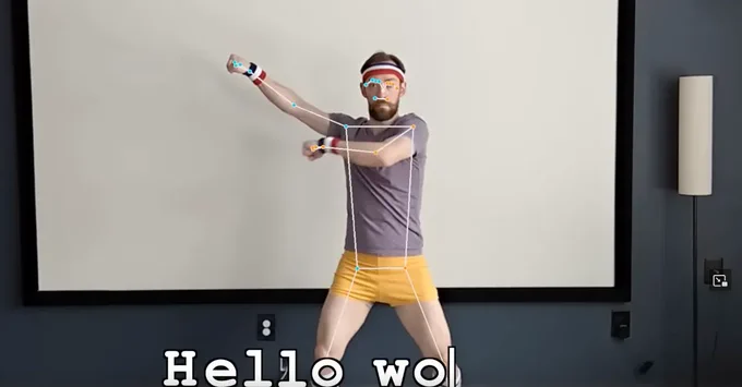 A man making gestures with his arms to type "hello wo" (world)