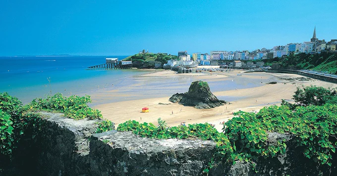Beach with rocks and town on seaside