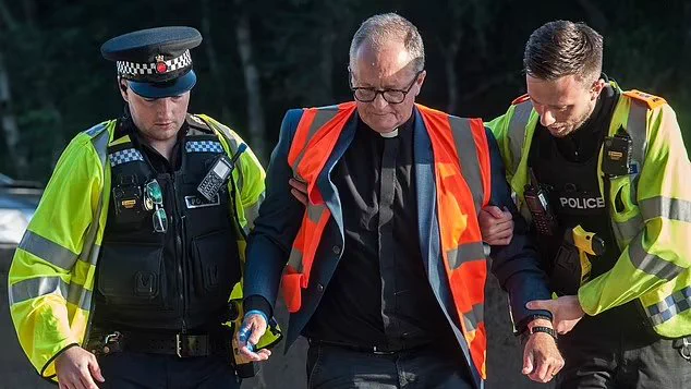 A picture of Mark being flanked by 2 police officers
