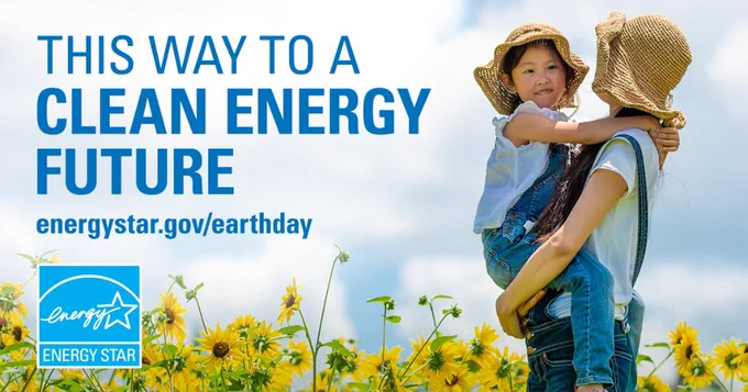 "This way to a clean energy future." Mom holds child in a field of sunflowers against a cloudy blue sky. Energy Star logo.