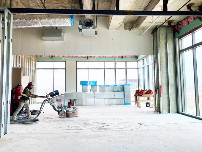 Grinding the terrazzo flooring where large pieces of broken marble are hand laid before the epoxy terrazzo is poured and grinded.