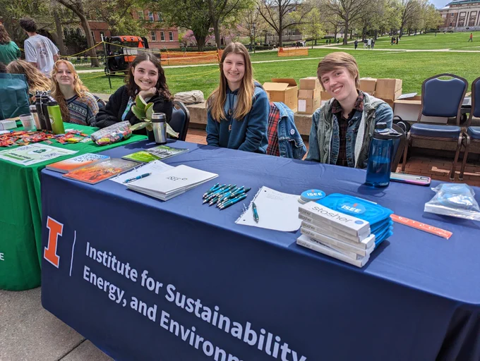 Photo of students and staff behind the iSEE Table and the SSC table at Green Quad Day. credit: iSEE Communications