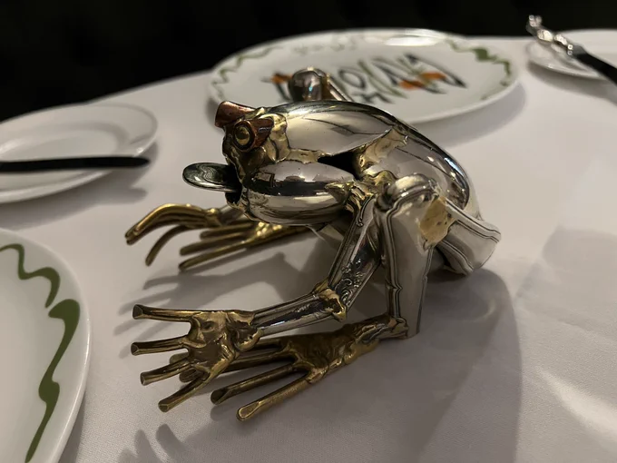 Silver ornament made of cutlery in the shape of a frog on a table at my restaurant