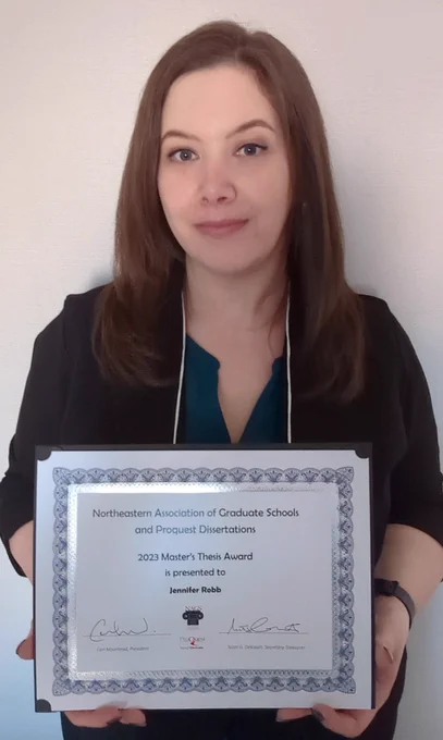 Jennifer Robb holding her certificate for the Master's Thesis Award from NAGS. 