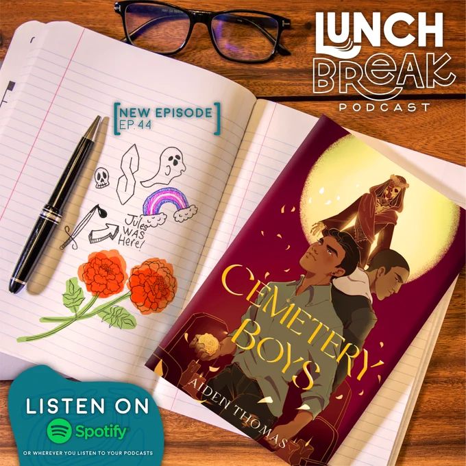 Cemetery Boys book lays flat on top of a notebook on a wooden table. There are doodles in the notebook. The LunchBreak Podcast logo is in the top right corner, and the Listen Now on Spotify snipe is in the lower left corner of the image. 