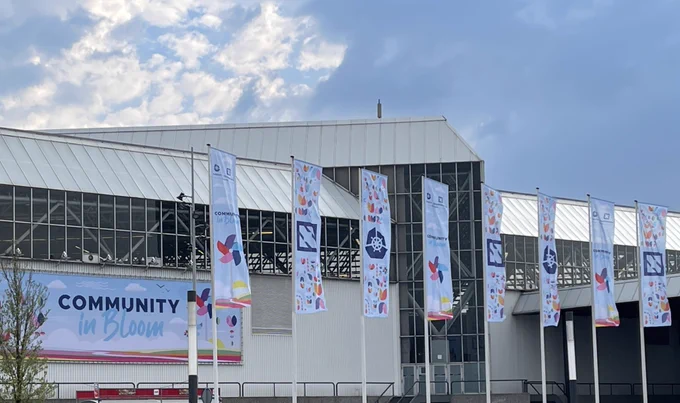 Conference center building with CloudNativeCon KubeCon banners