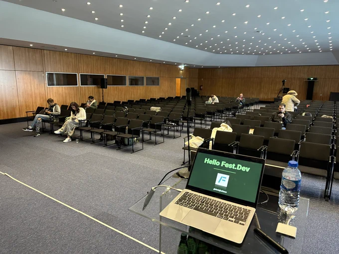 Laptop with my slides open and a room with chair as some people