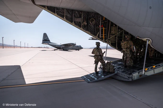 Dutch military personnel inspecting a plane.