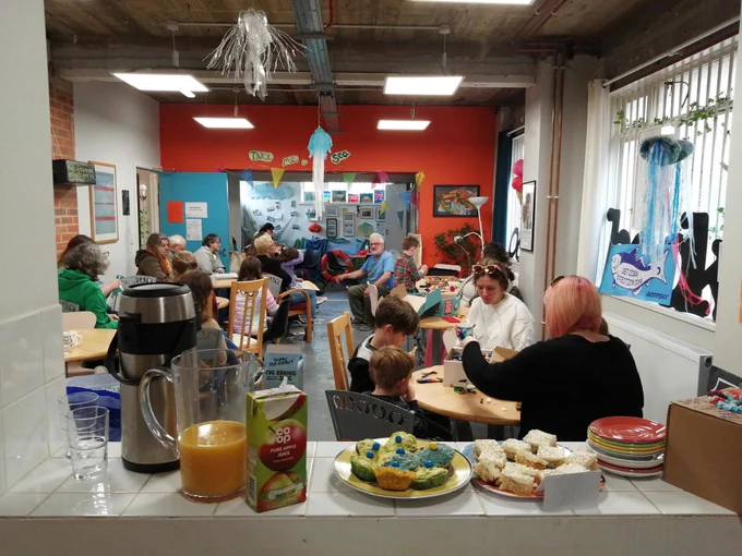 People listening to Storytelling at the Making Waves event at October Books 22.4.23. With cakes too.