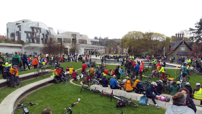 Cyclists in front of Scottish Parliament building 