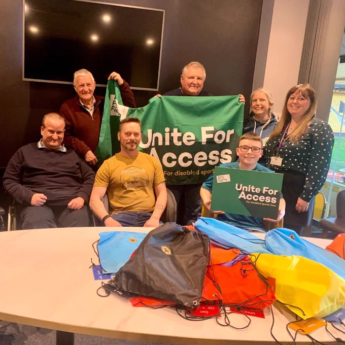 Wolves Disability Access Officer (DAO) Laura Wright and members of Wolves Disabled Supporters Association (DSA), posing for a photo after putting together comfort packs.