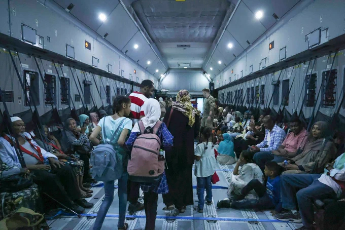 Inside an RAF evacuation flight made up of evacuates from Sudan including children.
