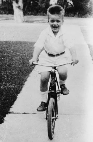 As a young boy, Briscoe rides a bike in Uvalde. From the Dolph Briscoe Collection.