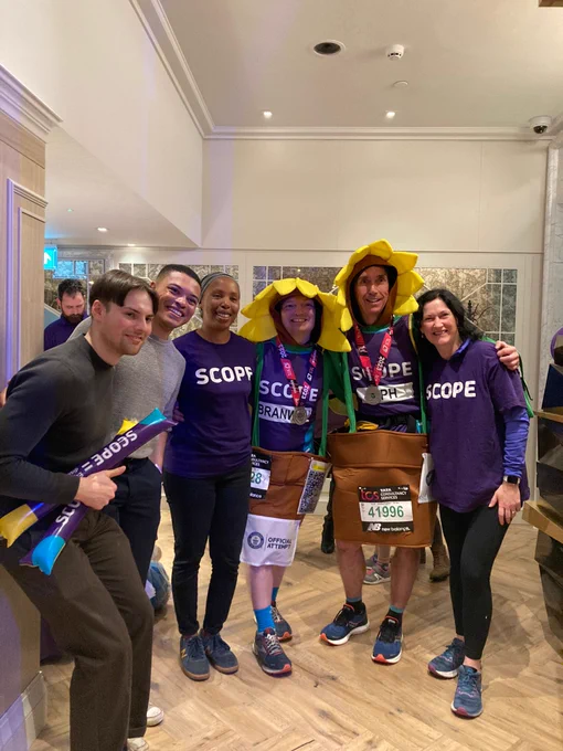 Scope runners, dressed as sunflowers, with supporters at Scope's post-race reception.