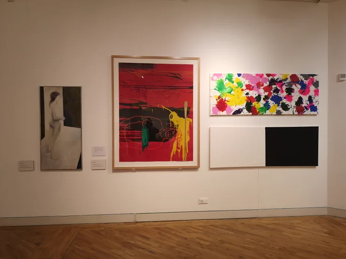 4 different size paintings on the wall of an art gallery.
