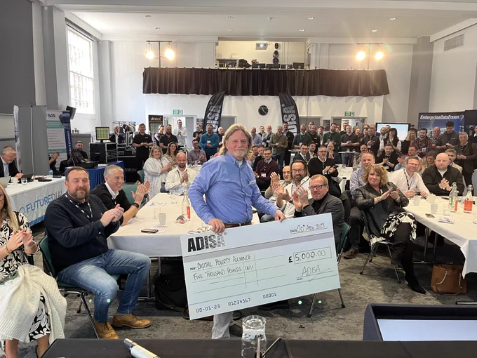 Paul Finnis receiving a cheque for £5000 from ADISA
