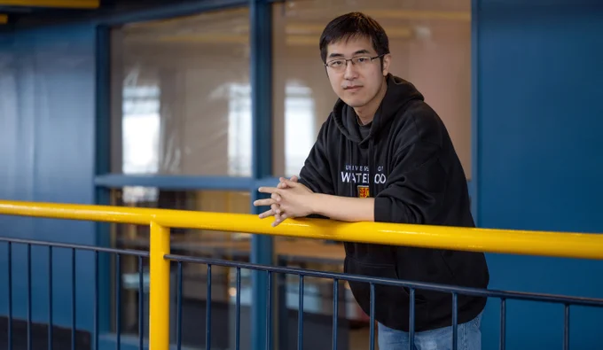 In the photo is Professor Hong Zhang in the Davis Centre, the building that houses the Cheriton School of Computer Science.