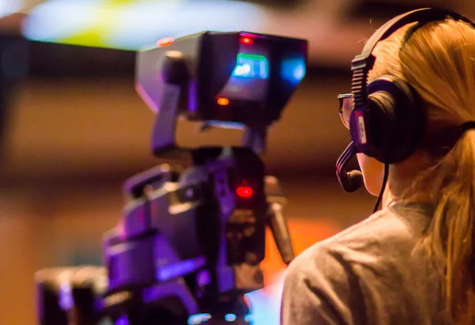 picture from behind a person looking into a video camera