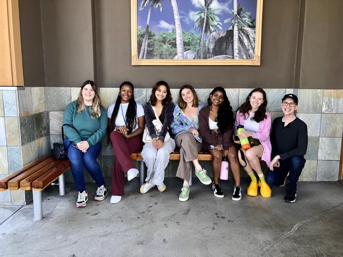 Seven people of the PRRISM research lab sitting outside before lunch
