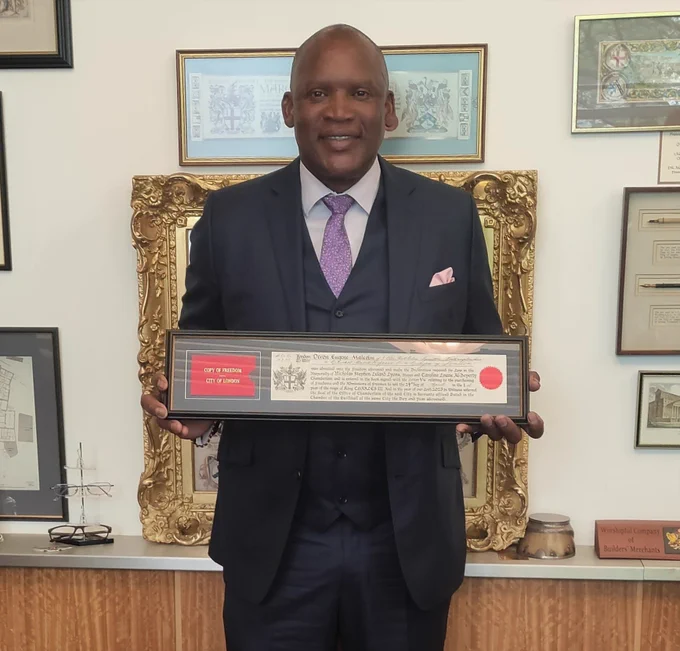 Former England cricketer Devon Malcolm, pictured with his Freedom of the City of London certificate, which he received today, in recognition of his sporting achievements. The Jamaican-born fast bowler attended his ceremony at Guildhall this afternoon.