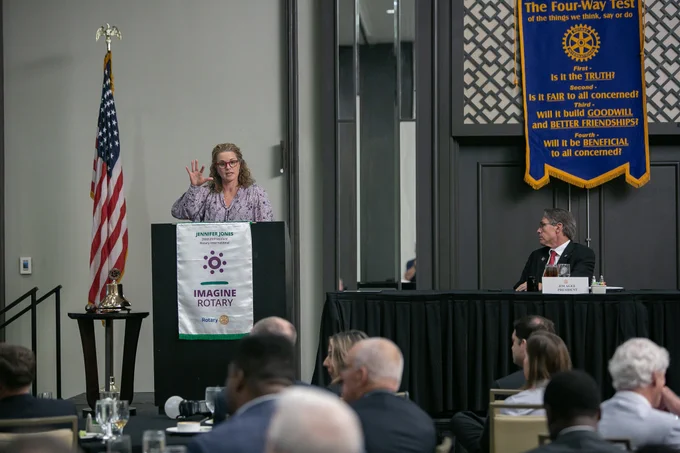 molly curry speaking at a podium