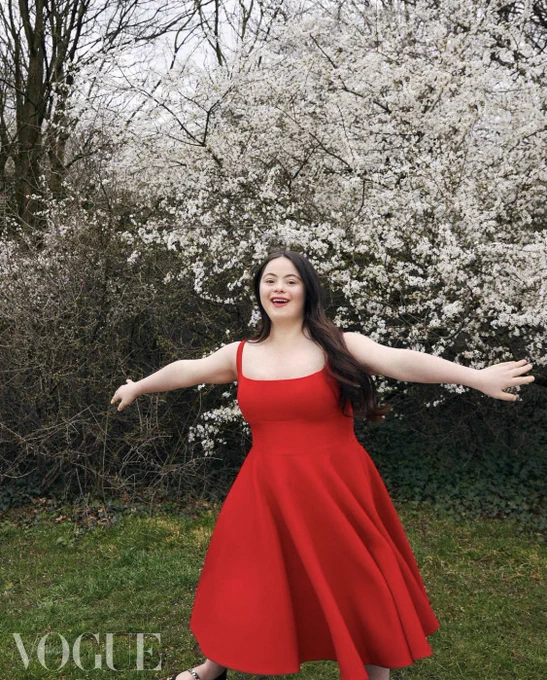 Ellie Goldstein, who has Down’s syndrome, wears a red strap dress.
