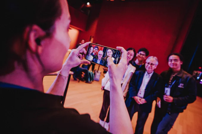 CHI attendees talking an photo with Hiroshi Ishii