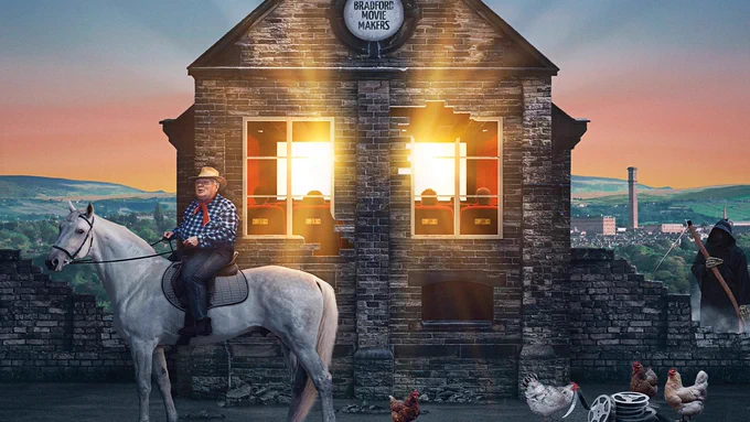 The film poster from the documentary 'A Bunch of Amateurs'. A man, dressed as a cowboy, is riding a horse. The figure of Death is stood to the side, along with some chickens pecking at old film reels. Behind them is an old building with a sign reading "Bradford Movie Makers". Inside, people are watching a film.