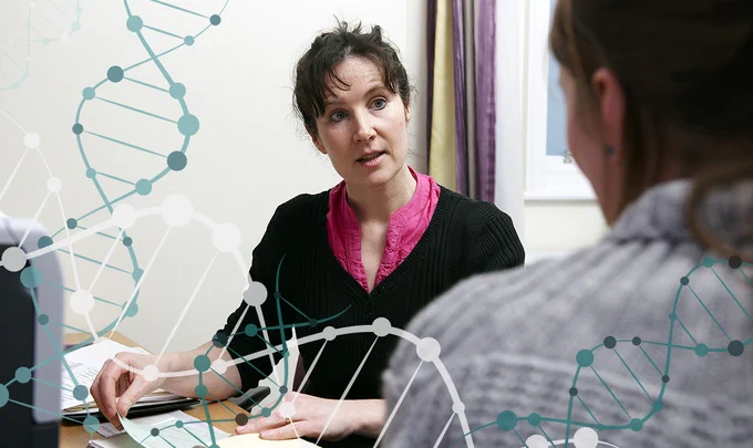 A photo of a clinician talking to a patient in her doctors surgery.