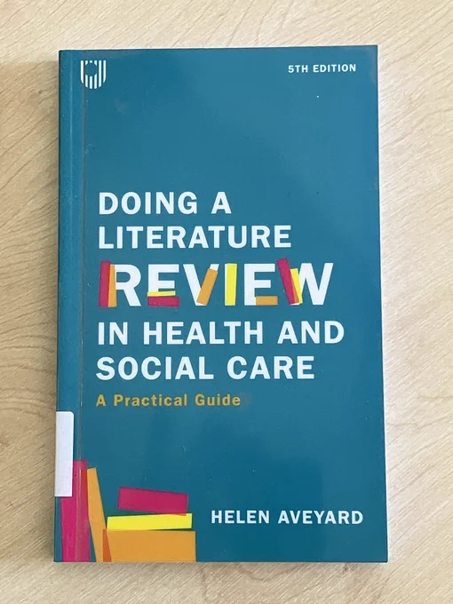 A book - Doing a literature review in Health and social care by Helen Aveyard, 5th edition. The cover is teal and features stylised images of books.