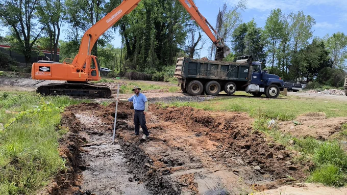 Joseph Hoffman checking grade on the forebay cleanout of the Lenoir Stormwater Wetland. 