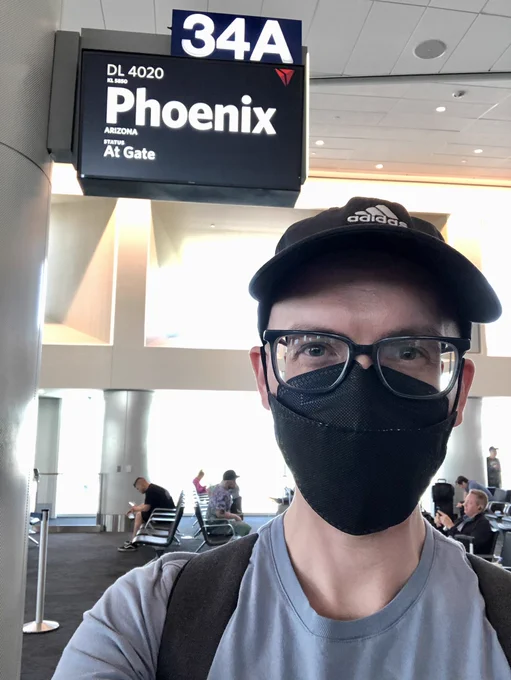 Timothy Williamson near an LAX airport sign that says “Phoenix” before boarding a flight to SBM 2023