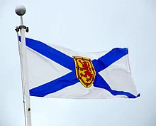 Nova Scotia flag blowing in the wind against a sky backdrop. 