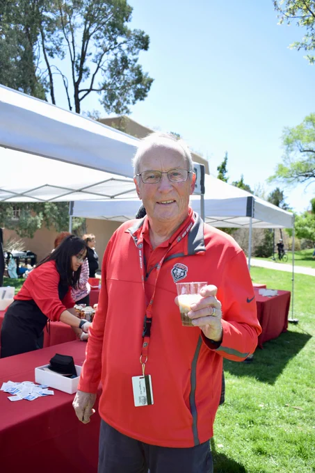 UNM's First Gentleman, Jeff Younggren, offers an ice cream float to passers by at the Ice Cream Social, near the Cactus Garden.
