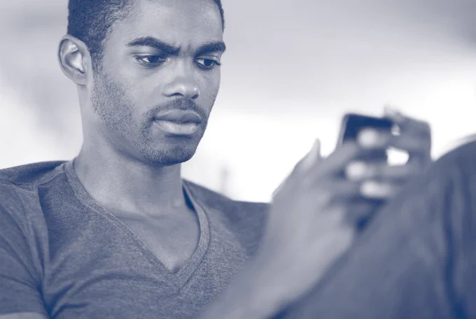 A man looks at his mobile phone