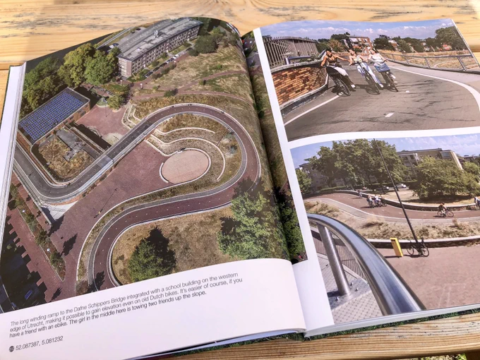 A coffee table book entitled “Fietspad”, which features large photos of cycle paths, intersections, and other infrastructure projects in the Netherlands.