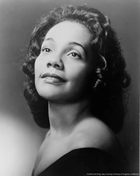 A black and white head-and-shoulders portrait of Coretta Scott King, facing front.