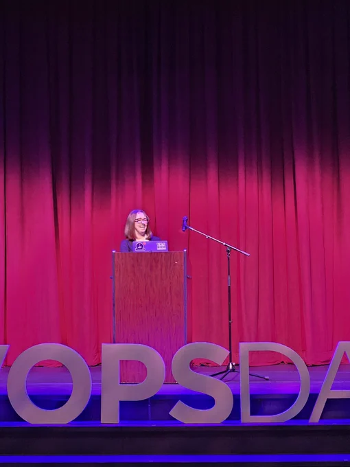 LunarLab co-founder Elizabeth Anderson speaking on stage at DevOpsDays Birmingham.