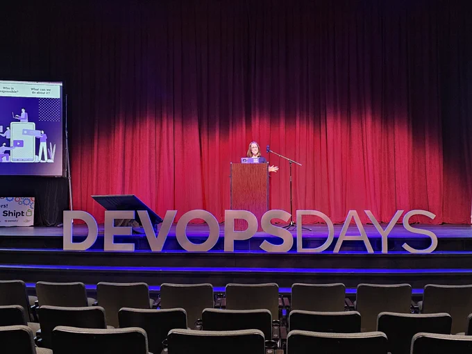 LunarLab co-founder Elizabeth Anderson speaking on stage at DevOpsDays Birmingham.