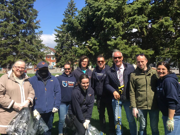 Faculty of social science and humanities faculty, staff, and students stand with Oshawa Mayor Dan Carter, and city councillor Derek Giberson at the community cleanup